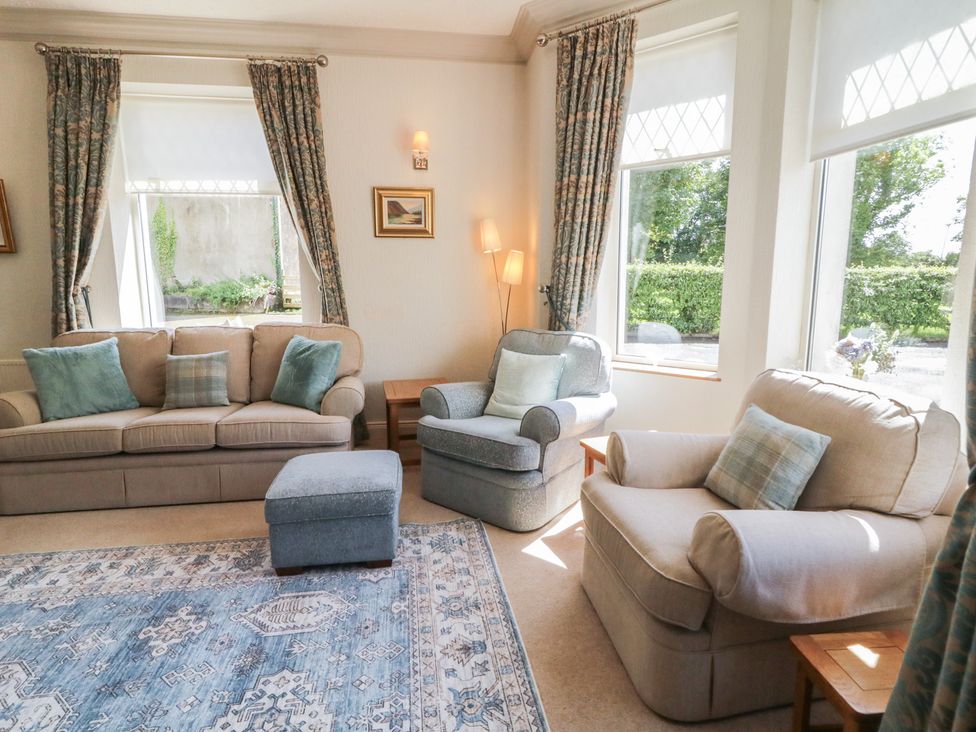 A living room with sofas and a footstool at Riverdene in Mountjoy