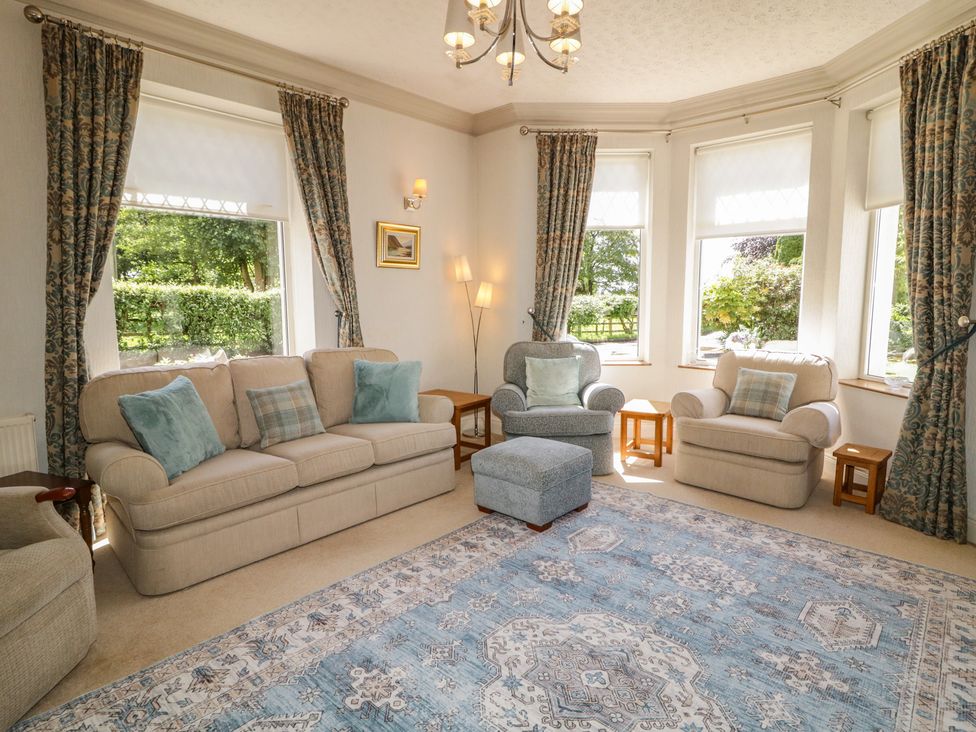 A living room with sofa and armchairs at Riverdene Mountjoy