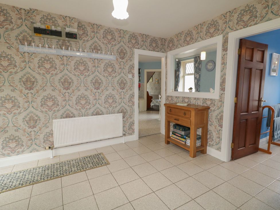 A hallway with a console table and mirror at Riverdene in Mountjoy