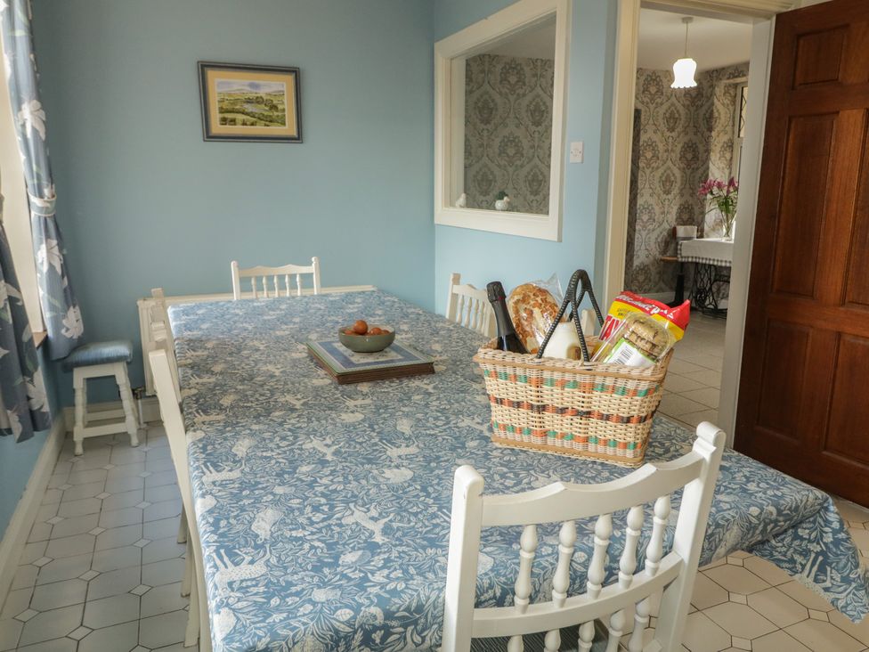 A dining room with a table and chairs at Riverdene in Mountjoy