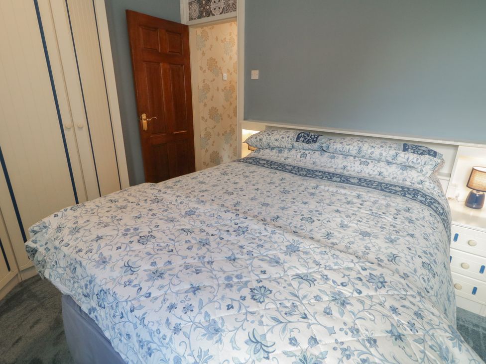 A bedroom with a bed and wardrobe at Riverdene in Mountjoy