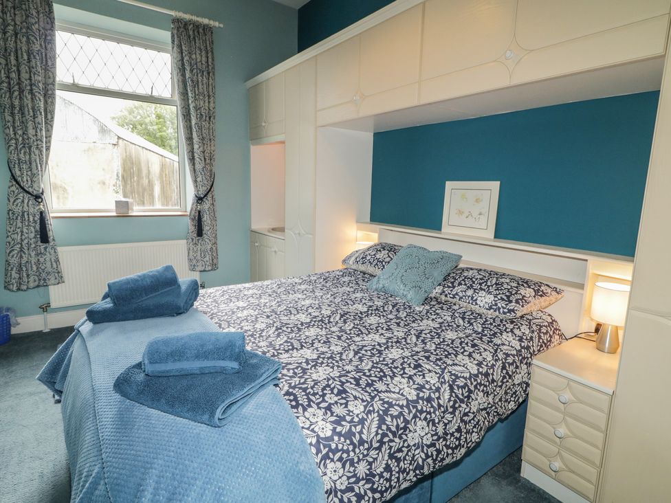 A bedroom with a bed and curtains at Riverdene in Mountjoy