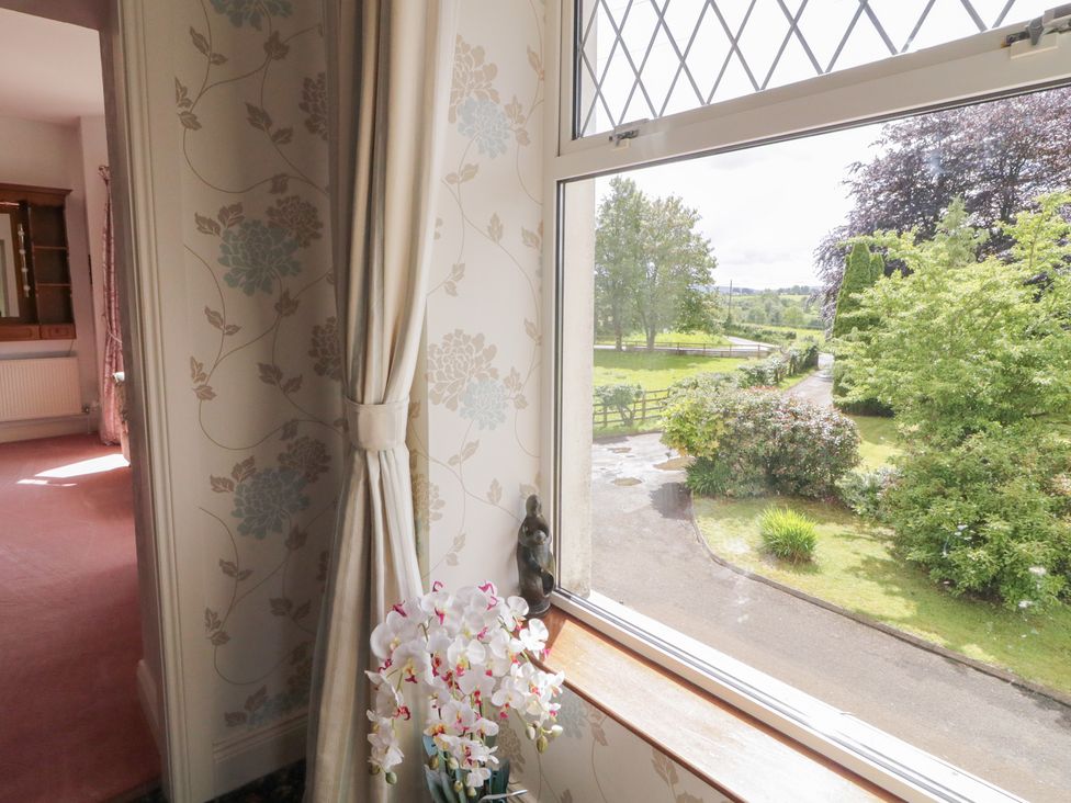 A window with flowers on a ledge at Riverdene in Mountjoy