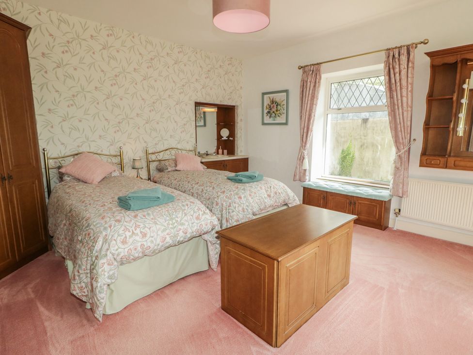 A bedroom with two beds and a dressing table at Riverdene in Mountjoy