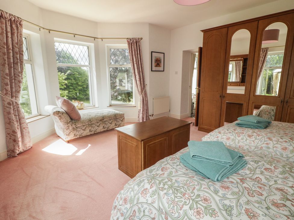 A bedroom with a bed and wardrobe at Riverdene in Mountjoy