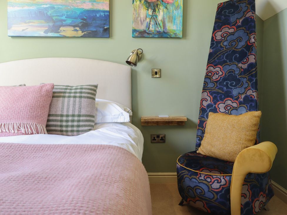 A bedroom with bed and chair at Ystwyth Cottage Newtown
