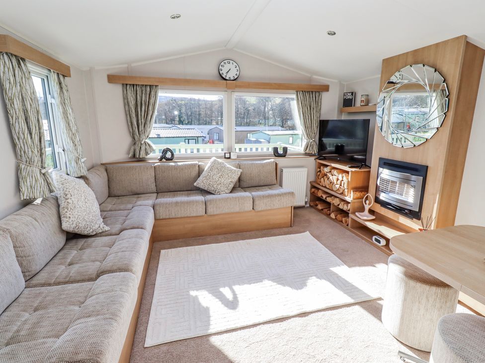A living room with a sofa and television at 75 Morpeth Mews Wooler