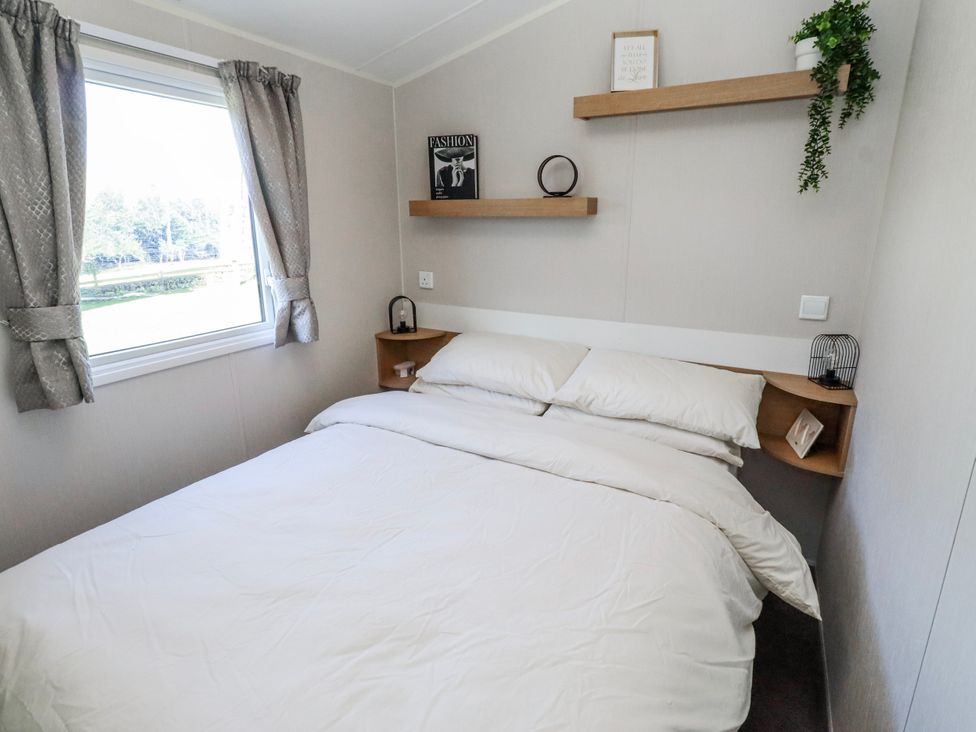 A bedroom with a bed and window at 75 Morpeth Mews Wooler