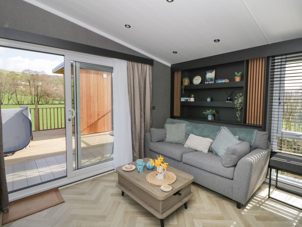 A snug with a sofa and a coffee table at Dawn's Rest Nantmel near Rhayader