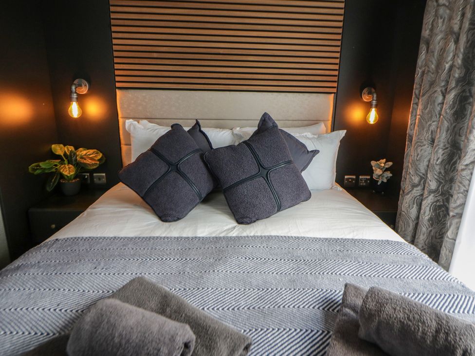 A bedroom with a bed and pillows at Dawn's Rest in Nantmel near Rhayader