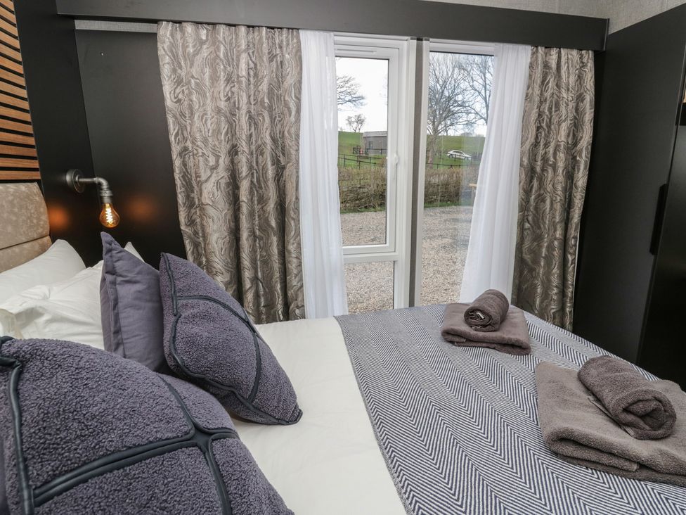 A bedroom with bed and window at Dawn's Rest in Nantmel near Rhayader