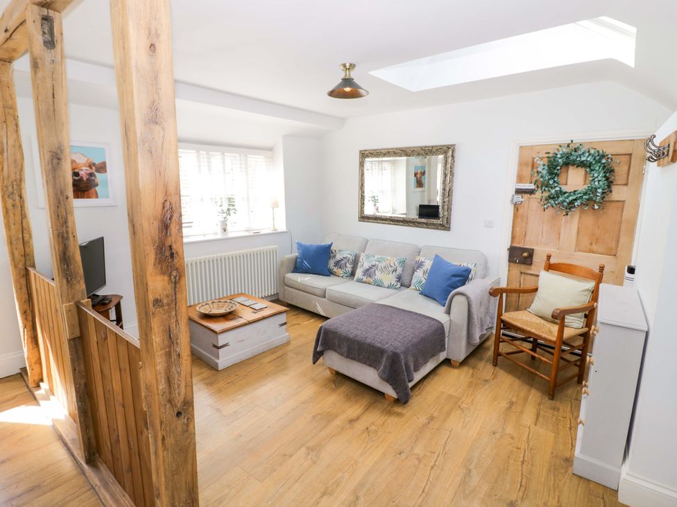 A living room with a sofa and coffee table at Halliday’s Cottages - The Cottage, Greetham near Cottesmore