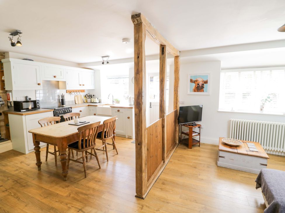 A kitchen with a table and chairs at Halliday’s Cottages - The Cottage in Greetham near Cottesmore