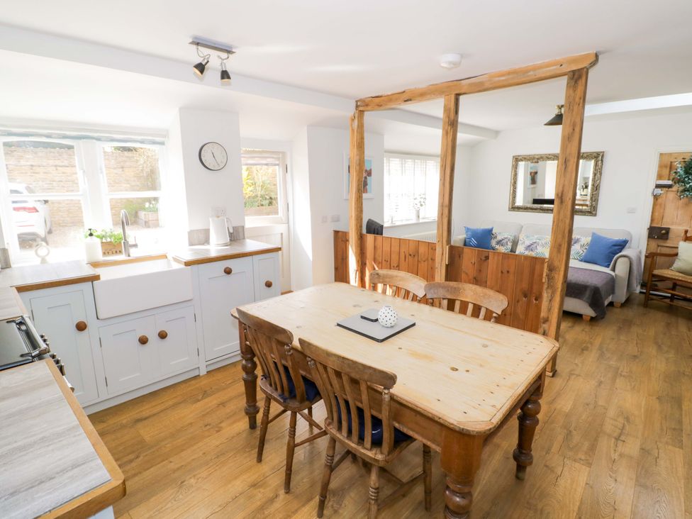 A dining room with a wooden table and chairs at Halliday’s Cottages - The Cottage Greetham near Cottesmore