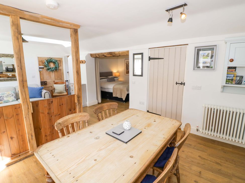 A dining room with a table and chairs at Halliday’s Cottages - The Cottage in Greetham near Cottesmore