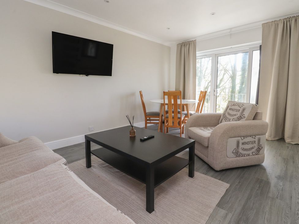 A living room with a television and dining area at Beacon Fell Cottage 1 Preston