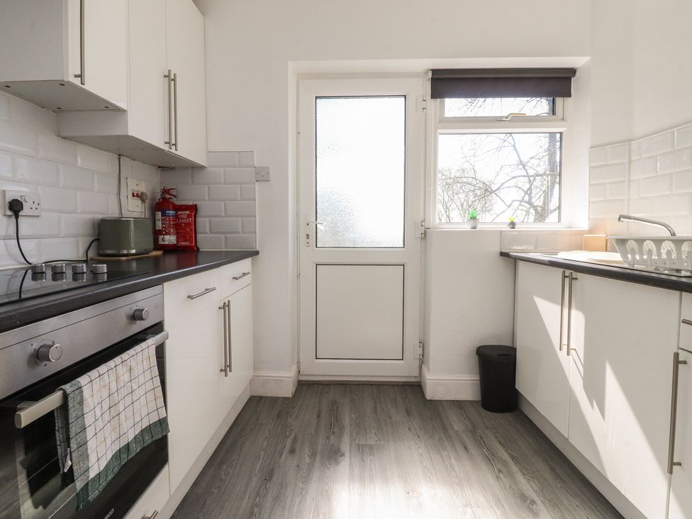 A kitchen with cabinetry and appliances at Beacon Fell Cottage 1 Preston