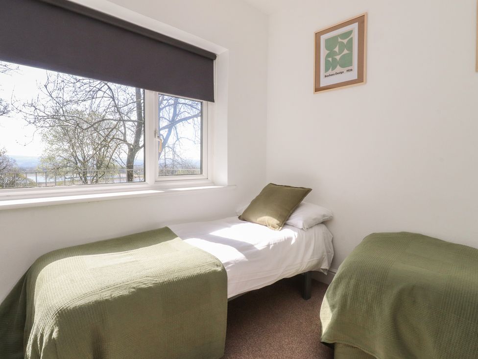 A bedroom with two beds and a window at Beacon Fell Cottage 1 Preston