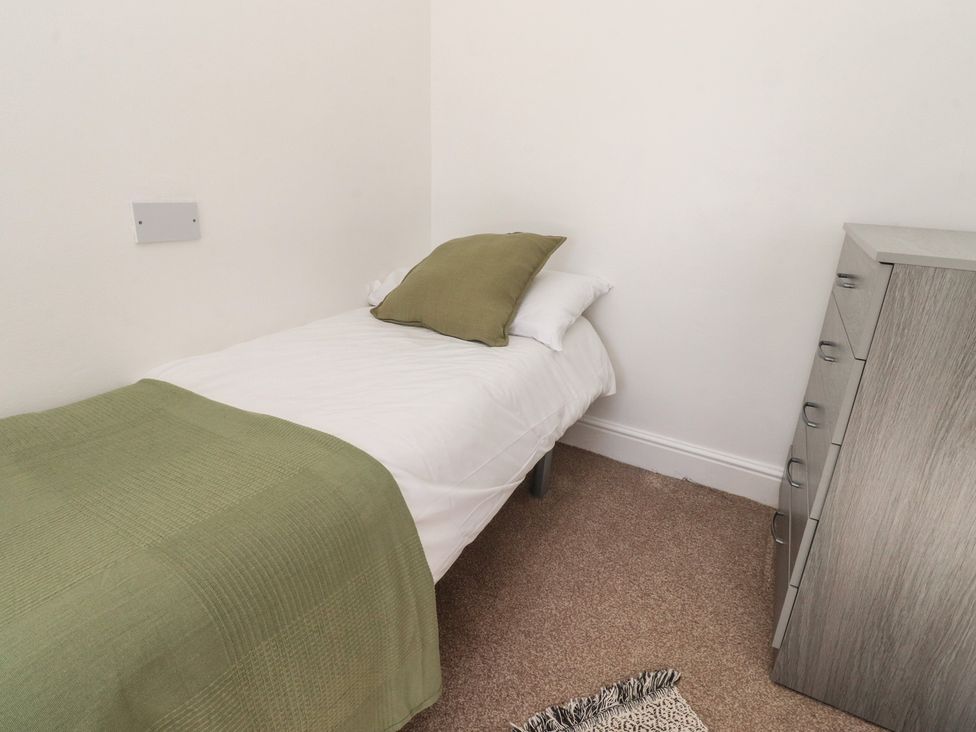 A bedroom with a single bed and chest of drawers at Beacon Fell Cottage 1 Preston