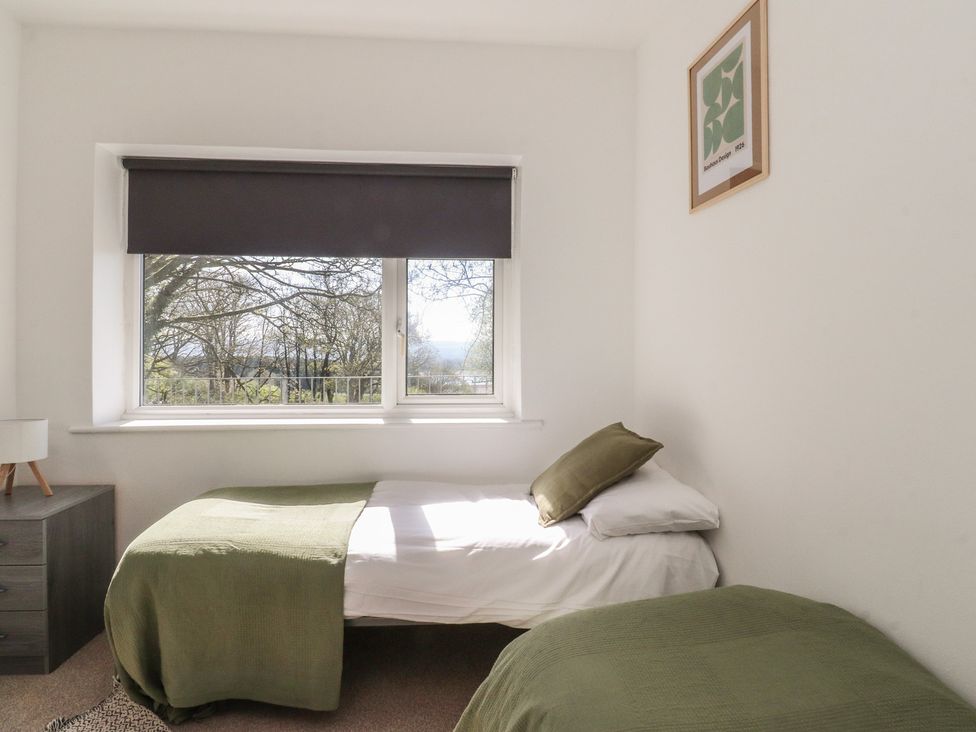 A bedroom with two beds and a window at Beacon Fell Cottage 1 Preston