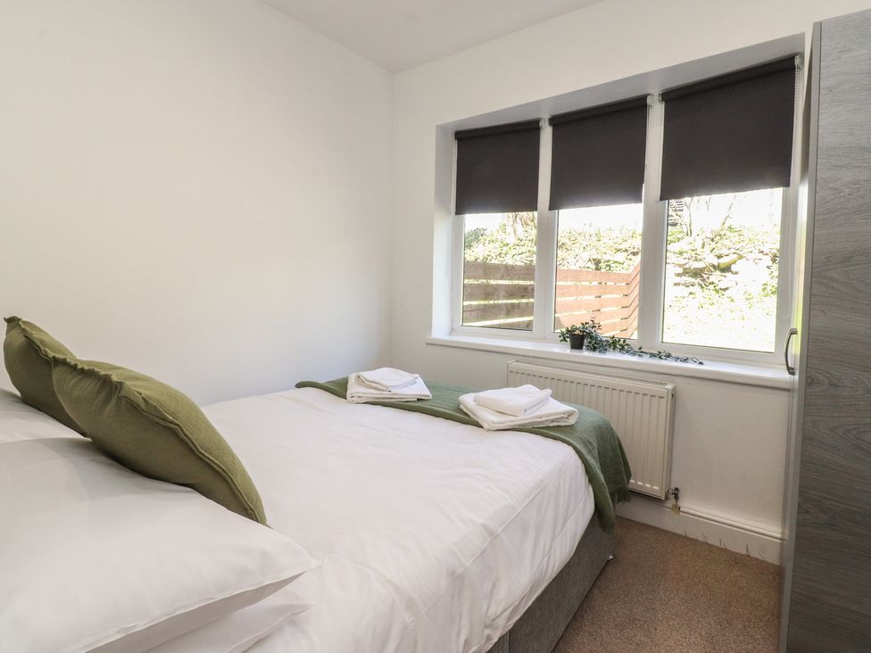 A bedroom with a bed and window at Beacon Fell Cottage 1 Preston