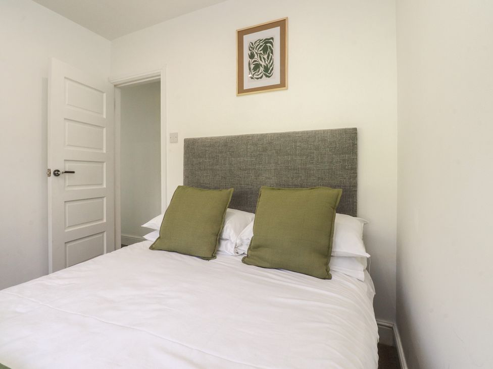 A bedroom with a bed and a wall art at Beacon Fell Cottage 1 Preston