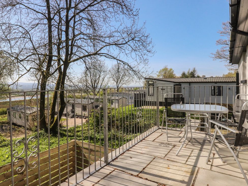 An outdoor area with a balcony and table at Beacon Fell Cottage 1 Preston