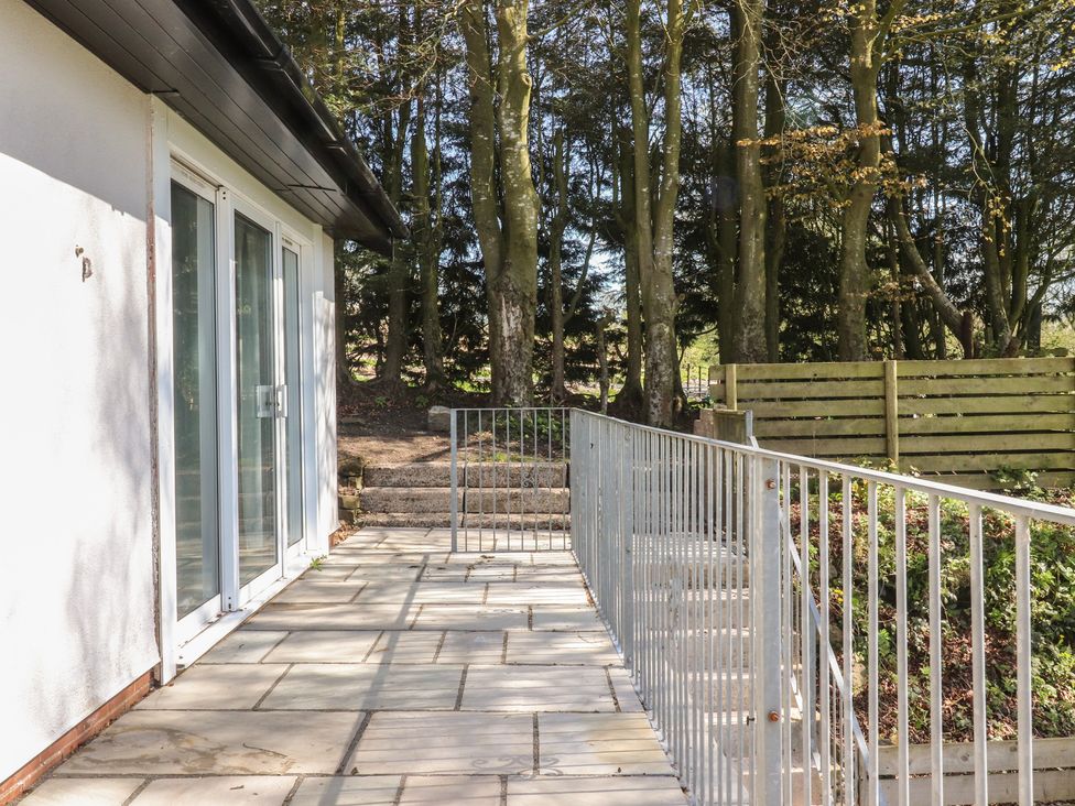 An outdoor area with patio and trees at Beacon Fell Cottage 1 Preston