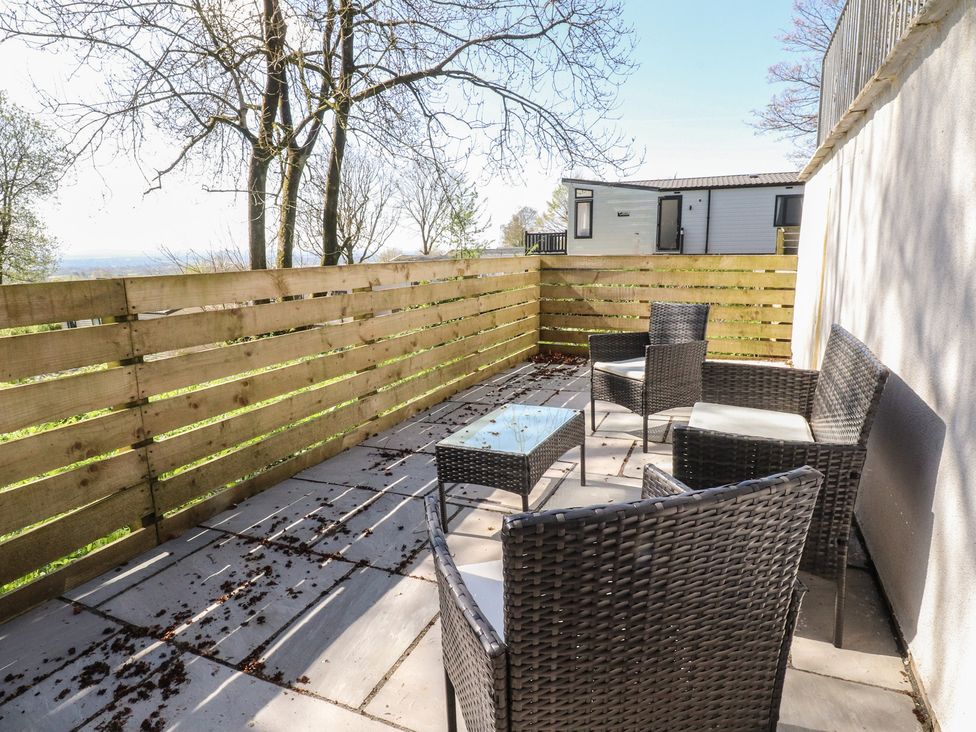 A patio with seating and a table at Beacon Fell Cottage 1 Preston