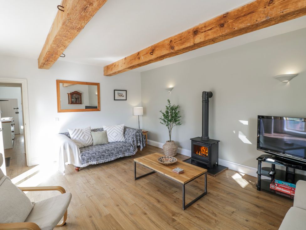 A living room with a sofa and coffee table at Halliday’s Cottages - The Folly in Greetham near Cottesmore