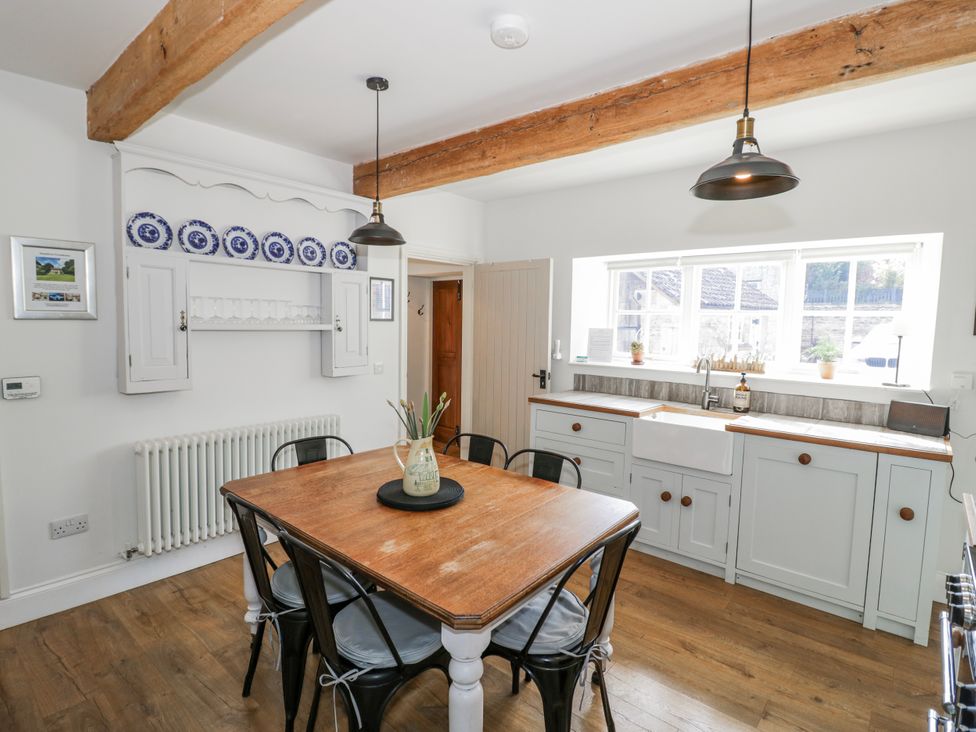 A kitchen with a table and chairs at Halliday’s Cottages - The Folly Greetham near Cottesmore