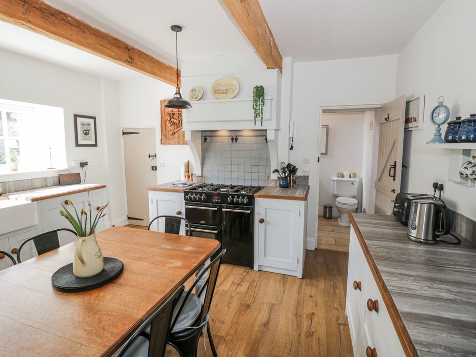 A kitchen with a table and chairs at Halliday’s Cottages - The Folly in Greetham near Cottesmore