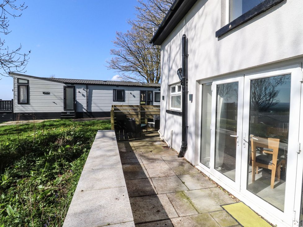 An outdoor area with a deck and table at Beacon Fell Cottage 2 Longridge