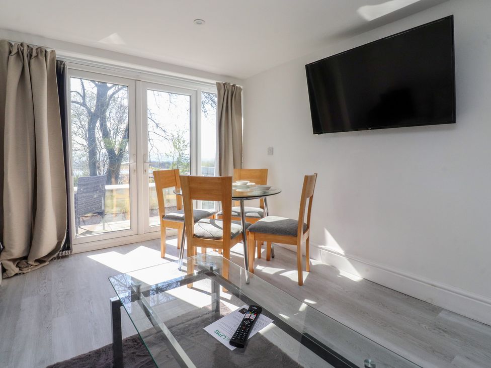 A dining room with a table and chairs at Beacon Fell Cottage 2 Longridge