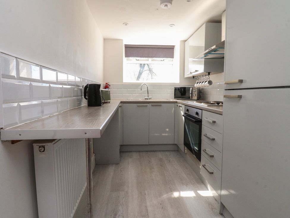 A kitchen with a sink and appliances at Beacon Fell Cottage 2 Longridge