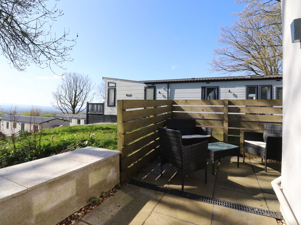 A garden area with chairs and table at Beacon Fell Cottage 2 Longridge