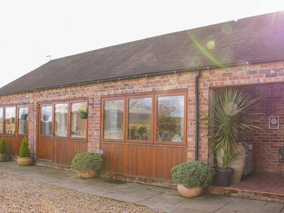 An outdoor view of a brick building with windows at Herdwick Cottage in Much Wenlock