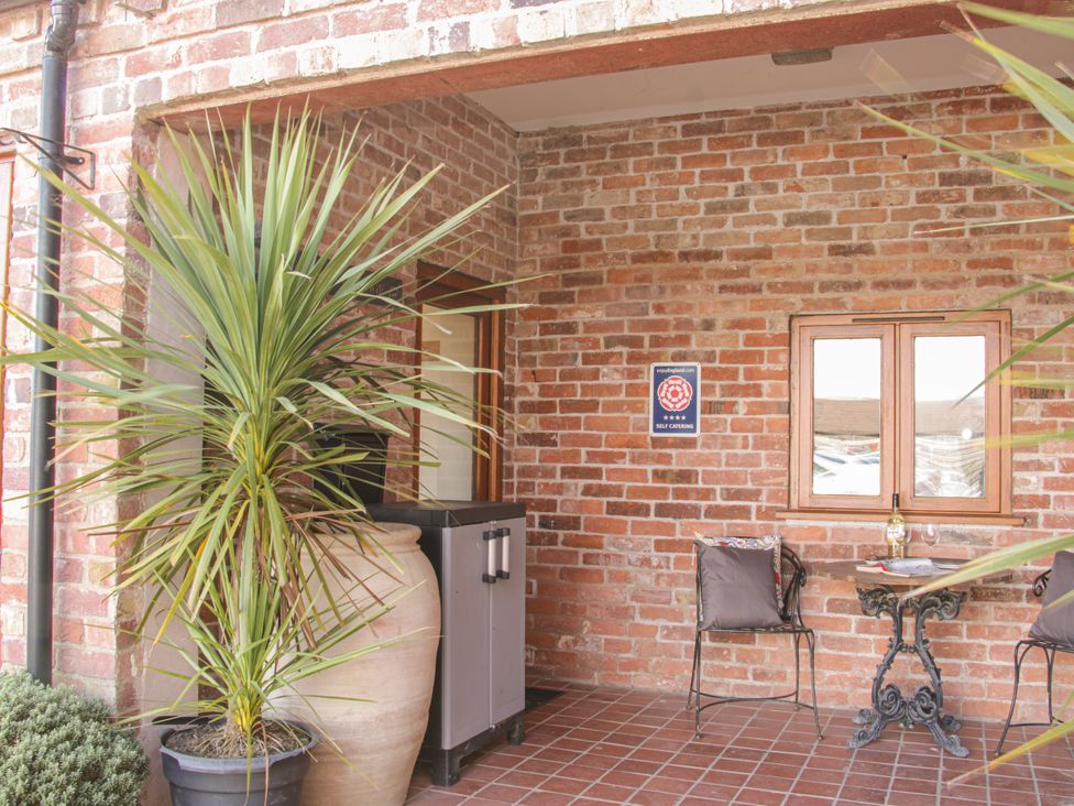 An outdoor area with furniture and plants at Herdwick Cottage in Much Wenlock