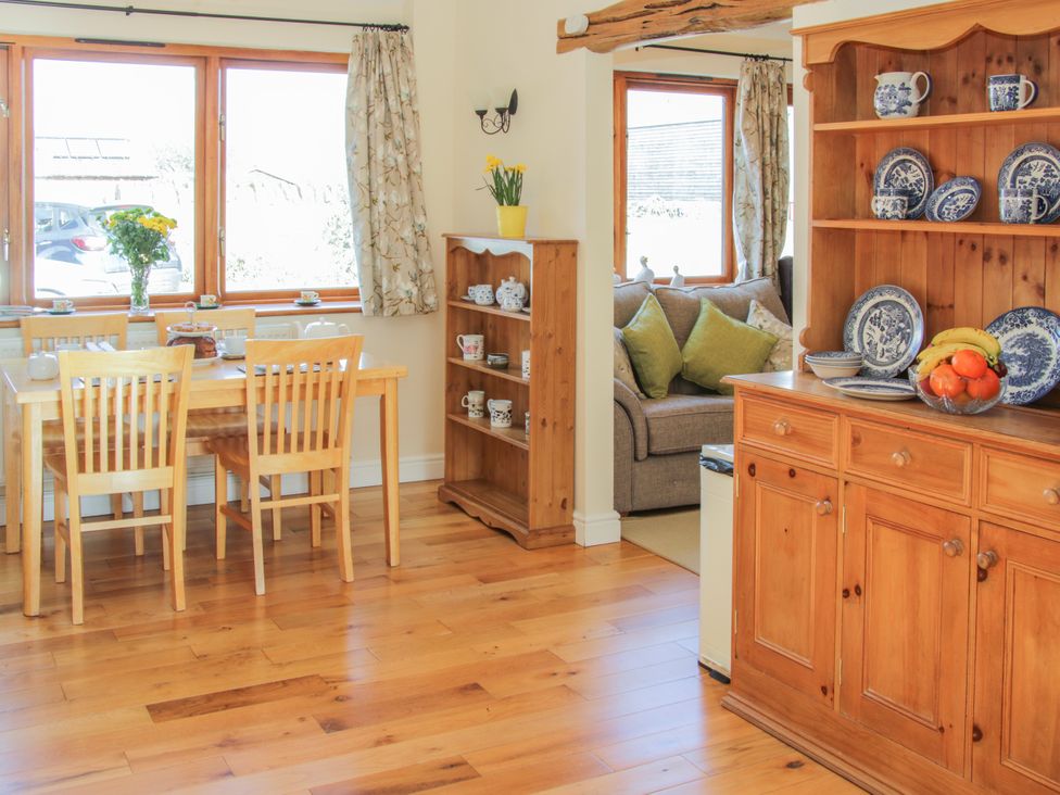 A dining room with a table and chairs at Herdwick Cottage in Much Wenlock