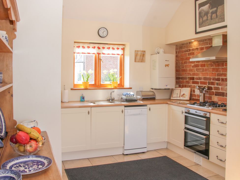 A kitchen with a sink and stove at Herdwick Cottage Much Wenlock