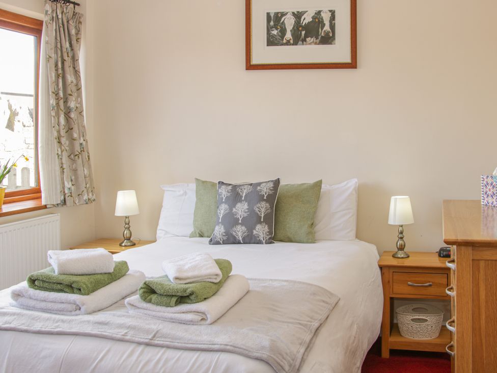 A bedroom with a bed and towels at Herdwick Cottage in Much Wenlock