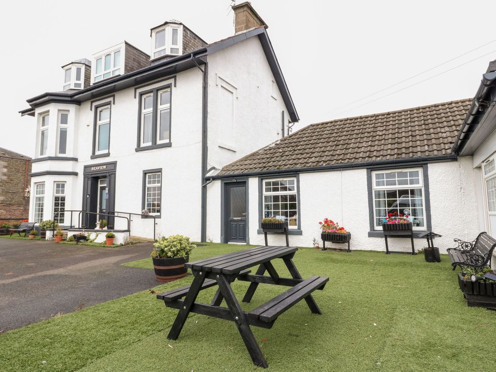An outdoor area with a building and a picnic table at Seaview Wellness Retreat in Carnoustie