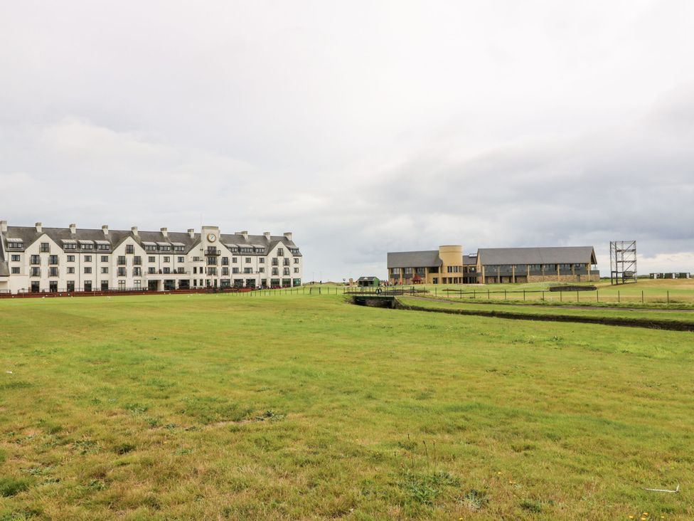 An outdoor view featuring buildings and grass at Seaview Wellness Retreat in Carnoustie