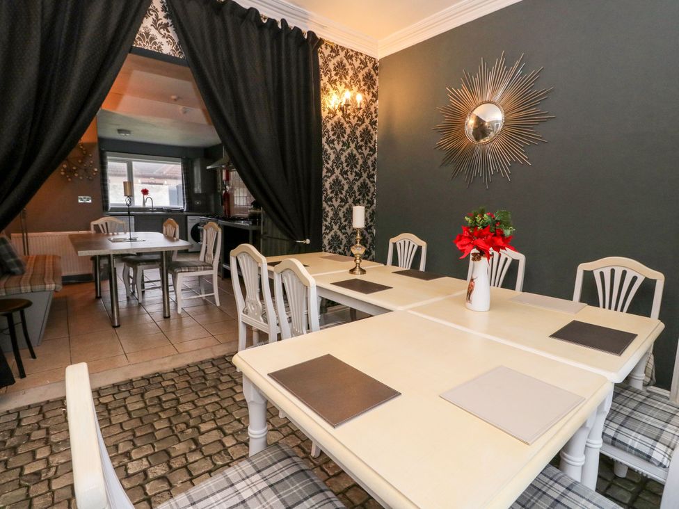 A dining room with tables and chairs at Seaview Wellness Retreat in Carnoustie