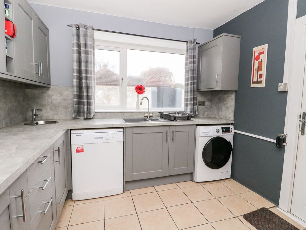 A kitchen with a sink and appliances at Seaview Wellness Retreat in Carnoustie