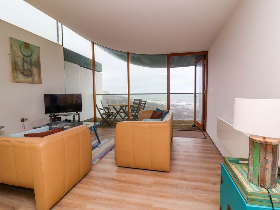 A living room with a television and sofas at 12 Nautilus in Westward Ho!