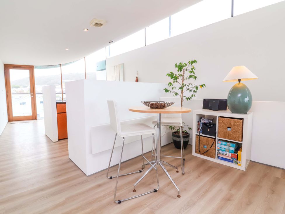 A dining area with a table and chairs at 12 Nautilus in Westward Ho!
