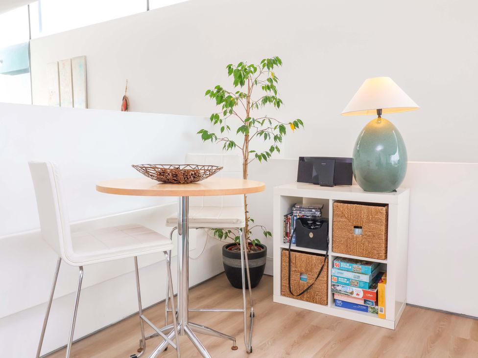 A dining area with a table and chairs at 12 Nautilus in Westward Ho!