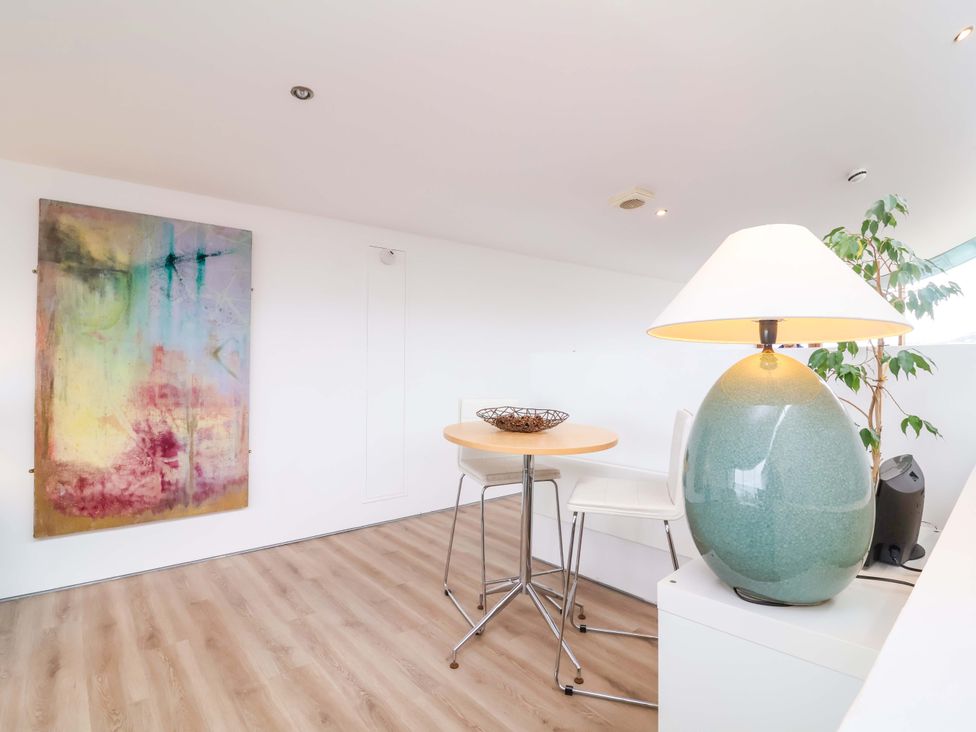 A dining area with a table and chairs at 12 Nautilus in Westward Ho!