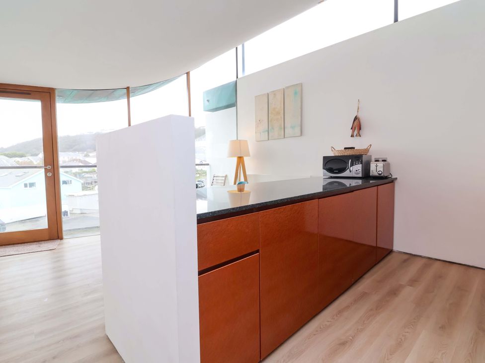 A kitchen with an island and appliances at 12 Nautilus in Westward Ho!